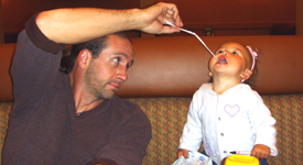 Catty and Daddy playing with a straw wrapper...